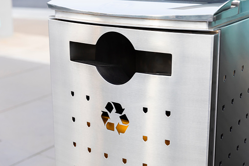 Close-up of a metal recycling bin, ready to contribute to a sustainable and eco-friendly environment.