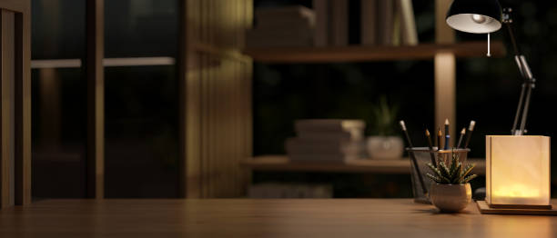 istock A cozy room at night with a wooden table featuring a designated space for displaying your product. 1989069316