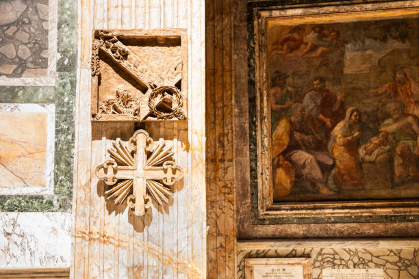 Pilgrims visiting the Vatican and walking in front of St. Peter's Square carrying a wooden cross