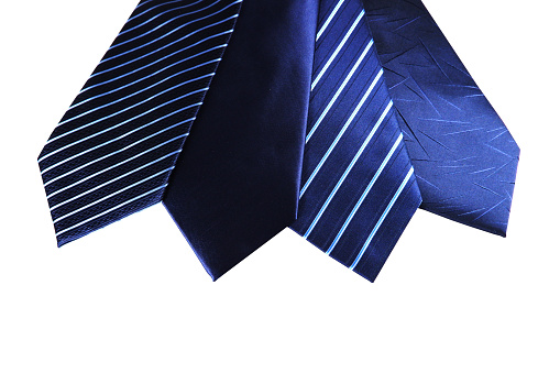 Group of neckties layered together side by side close-up view with white background