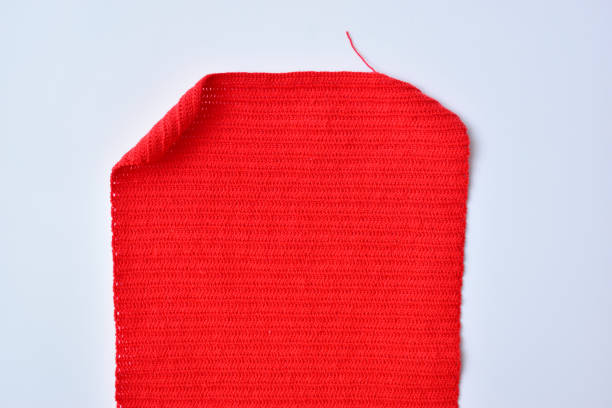 red wool knitted yarn texture, woolen fabric on white background