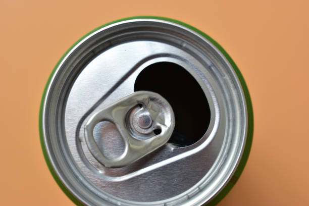 istock aluminum green drink cans on orange background, open cold fresh beverage 1989128996