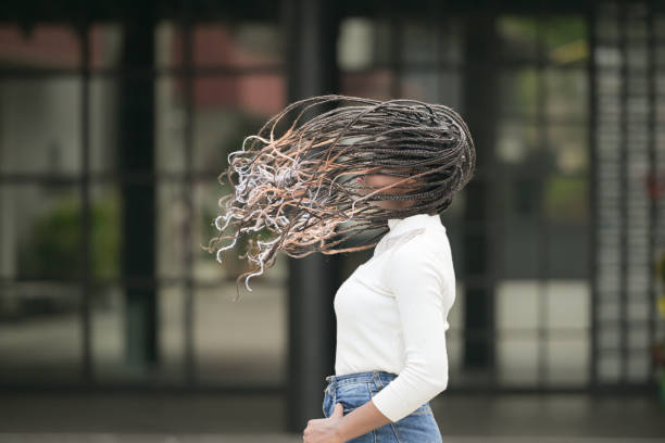 A young woman with his hairstyle and the atmosphere of living in the community.
