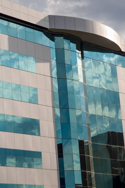 istock generic facade business building glass wall and windows, clouds reflection 1989136856