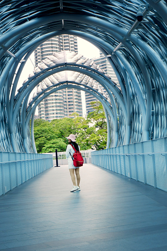 Woman in pedestrian walkway tunnel in Kuala Lumpur, Malaysia