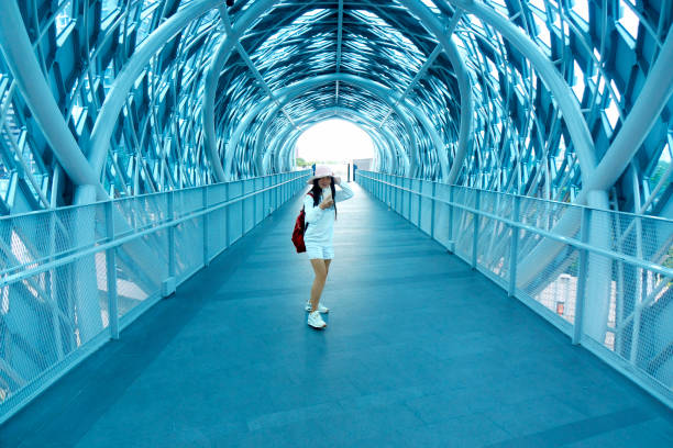 Woman in pedestrian walkway tunnel in Kuala Lumpur, Malaysia