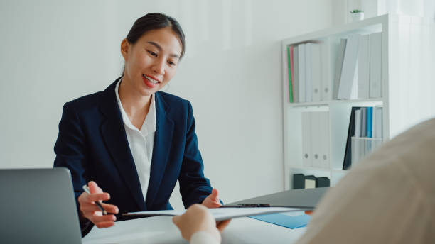 young asian woman pass job interview sit in front of hr manager at office. human resource, recruitment agency. - discussion interview talking place of work zdjęcia i obrazy z banku zdjęć