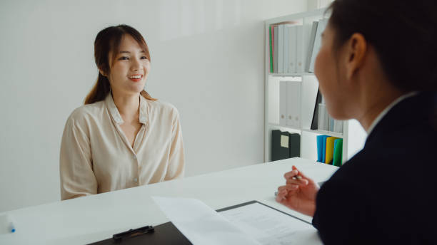 young asian woman pass job interview sit in front of hr manager at office. human resource, recruitment agency. - discussion interview talking place of work zdjęcia i obrazy z banku zdjęć