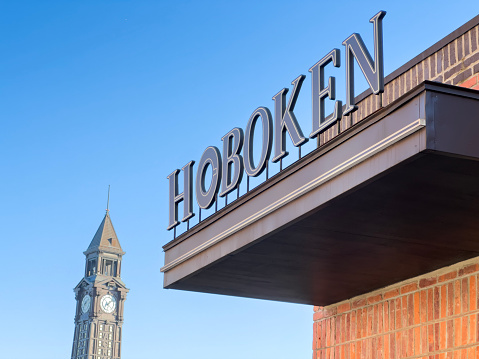 Hoboken train station clock tower  in front of a clear sky