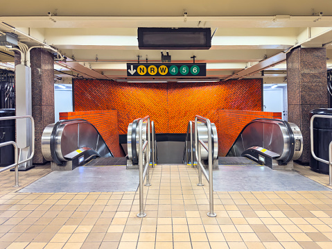 Wide angle shot of escalators in a subway underground tunnel in New York City