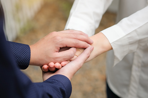 man and woman holding hands to take care and help each other.
