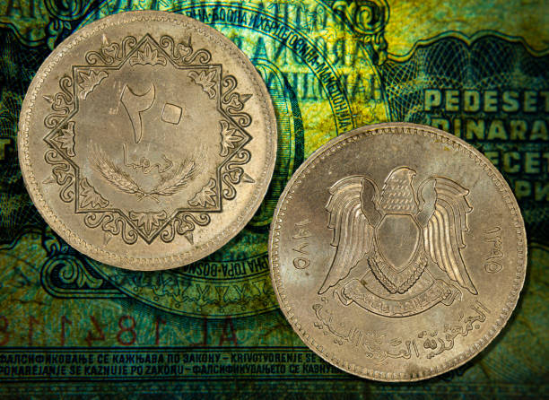 istock Vintage Libyan Jamahiriya dinar coins placed on a vibrant green tablecloth 1989205934