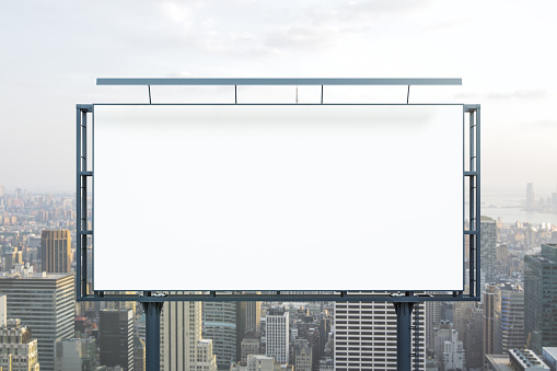 Blank white billboard on cityscape background at daytime, front view. Mock up, advertising concept