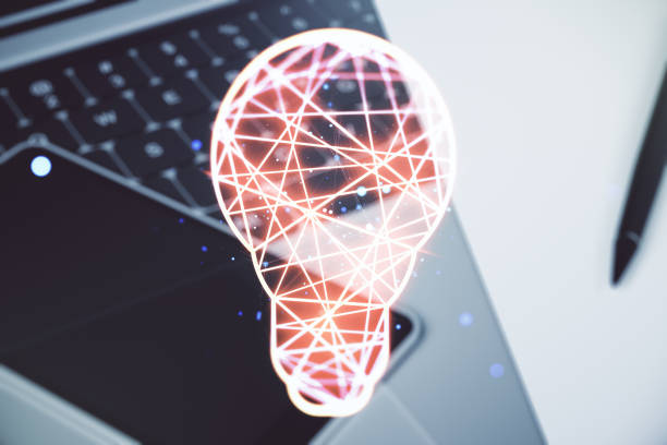 istock Double exposure of creative light bulb hologram on laptop background, research and development concept 1989209625
