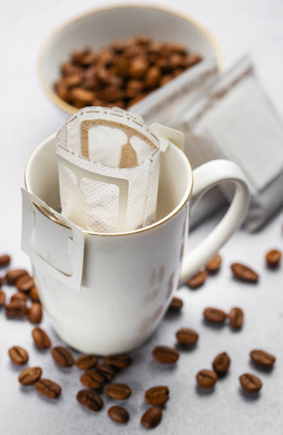 istock Drip coffee bag with ground coffee in  cup 1989271643