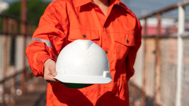 istock Giving a safety helmet. Safety first working concept. 1989308200