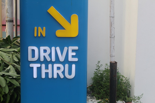Drive thru direction sign with blurred background