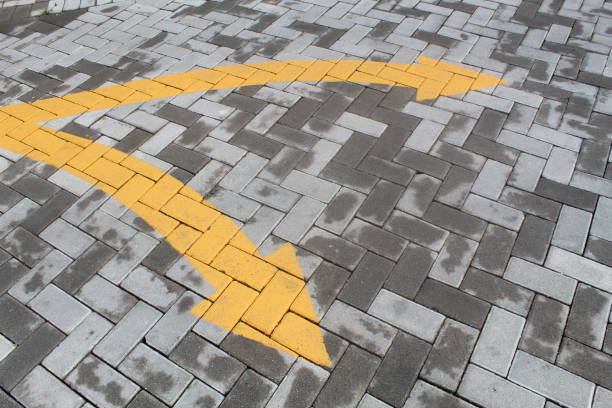 Two-way direction with yellow color on the pedestrian floor. suitable for symbol and direction concept
