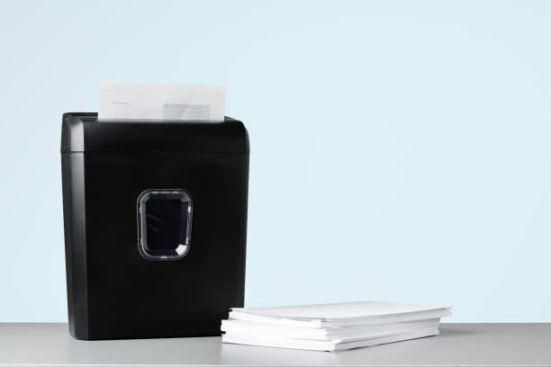 istock Office paper shredder on table against gray background 1989330418