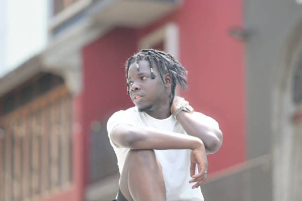 A young man with his hairstyle and the atmosphere of living in the community.