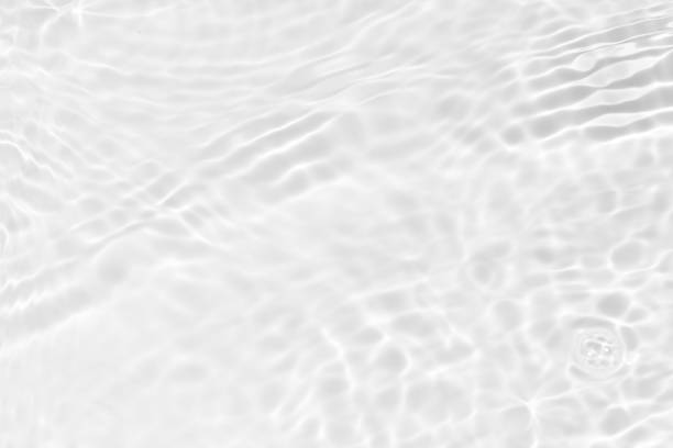 istock Water surface. Bluewater waves on the surface ripples blurred. Defocus blurred transparent blue colored clear calm water surface texture with splash and bubbles. Water waves with shining pattern. 1989368643