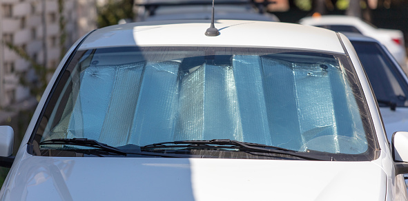 Reflective sun protection on car windshield.