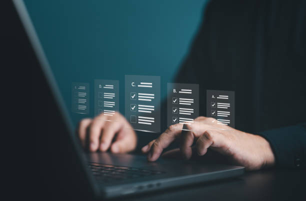 istock Businessman use laptop to take online survey with digital forms or checklists. Strategy and technology for success in modern world business trend, efficiency, transparency in organization or company. 1989390026
