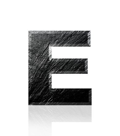 Close-up of three-dimensional slate alphabet letter E on white background.