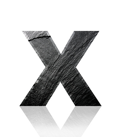 Close-up of three-dimensional slate alphabet letter X on white background.
