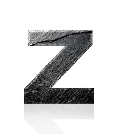 Close-up of three-dimensional slate alphabet letter Z on white background.