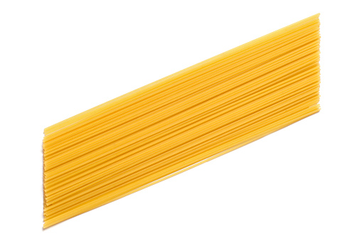 Long yellow spaghetti on white background. Pasta isolated. Natural pasta.