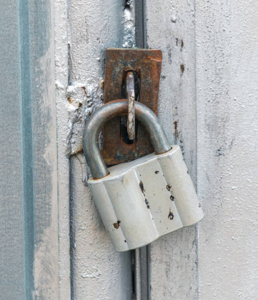 istock Old lock on a metal fence. Close-up 1989413428