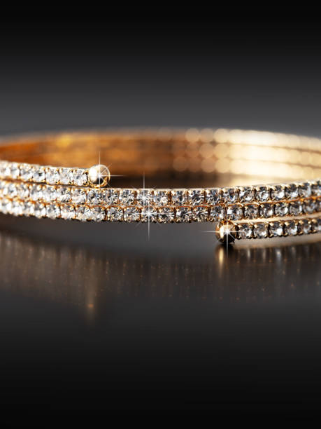 istock Gold bracelet isolated on black background 1989426621