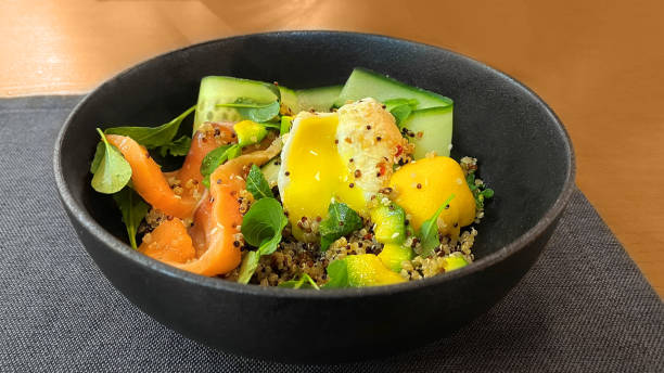 istock Salad with quinoa, arugula, red fish and poached egg for breakfast at the restaurant 1989428206