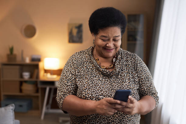 istock Black Senior Woman Using Phone Reading Text Messages 1989444376