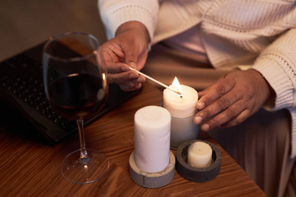 istock Black Woman Lighting Candles 1989444408