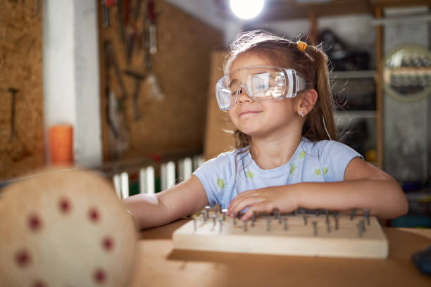Beautiful girl reparing some old furniture in garage.