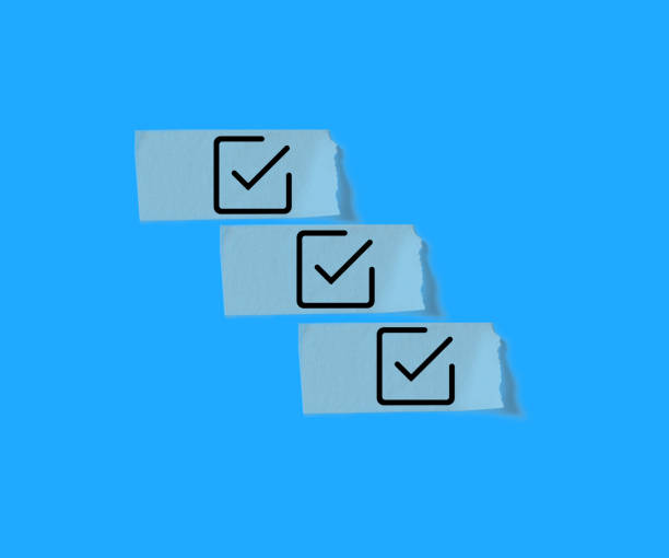 istock Checkbox on masking tape isolated on blue background. 1989452280