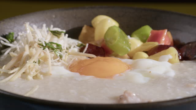Congee or rice porridge with pork and soft boiled egg, Chinese food.