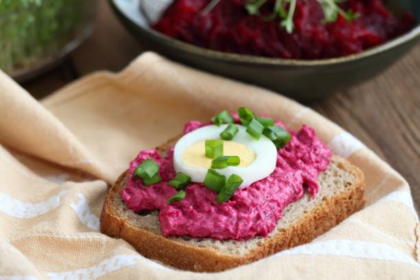 istock Beetroot mixed with goat cream cheese spreaded on whole grain bread. 1989490593