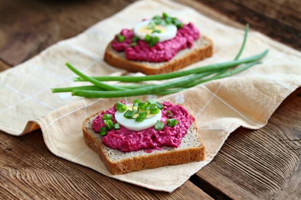 istock Beetroot mixed with goat cream cheese spreaded on whole grain bread. 1989490598