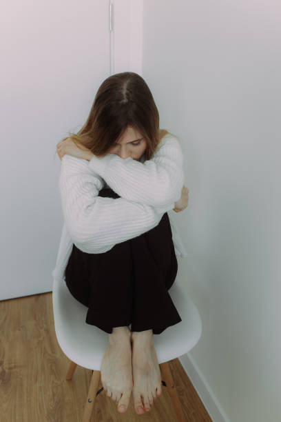 istock A young girl immersed in her thoughts sits on a chair on a white background, space for text. The concept of self-knowledge. Visual for psychotherapists and coaches 1989491121