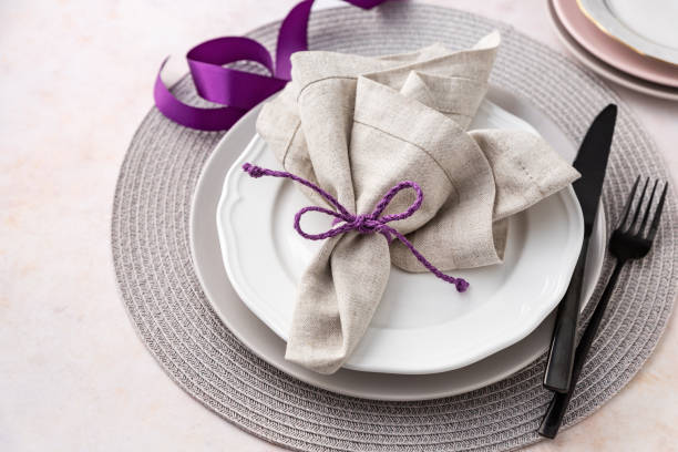istock Purple and grey napkin and plates arranged on table 1989507961