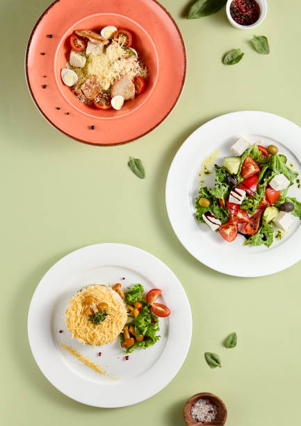 istock Top View of Assorted Salad Platter with Greek, Forest Glade, and Caesar Salads. 1989509086
