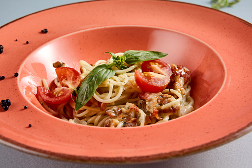 Delightful Carbonara pasta served in a terracotta dish, top view perfect for Italian cuisine recipes and food bloggers.