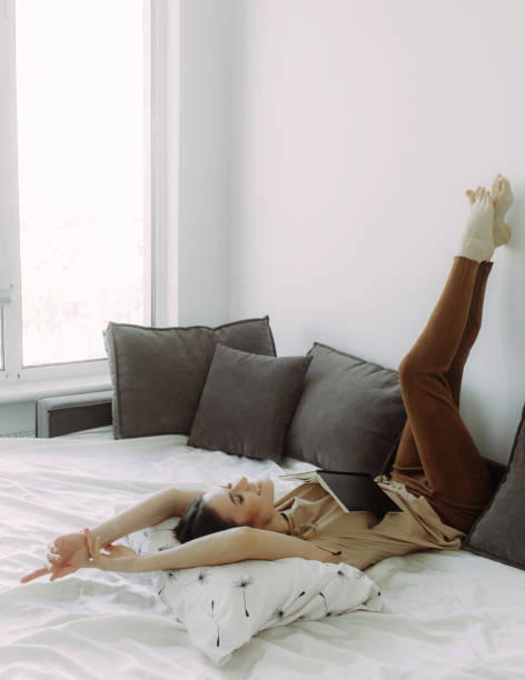 istock Smart girl with a notepad in her bedroom , on a white background with space for text. Brainstorming concept 1989510677