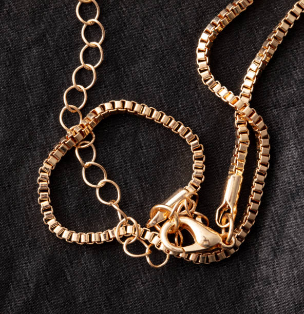 istock Gold chain on black silk fabric. Close-up 1989521766