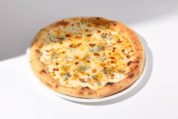 istock Italian Quattro Formaggi Pizza with Four Cheeses on White with Shadow 1989521826
