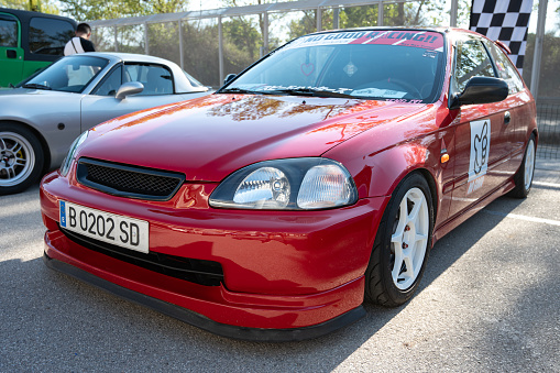 Montmelo, Spain – December 15, 2023: Front view of a nice and classic Honda Civic 6th generation EK type, red and tuned for street racing.