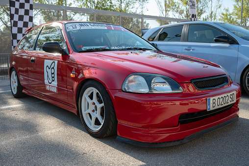 Montmelo, Spain – December 15, 2023: Front view of a nice and classic Honda Civic 6th generation EK type, red and tuned for street racing.